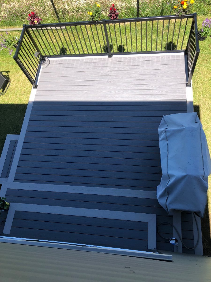 Two-tone grey composite deck with black railing seen from above